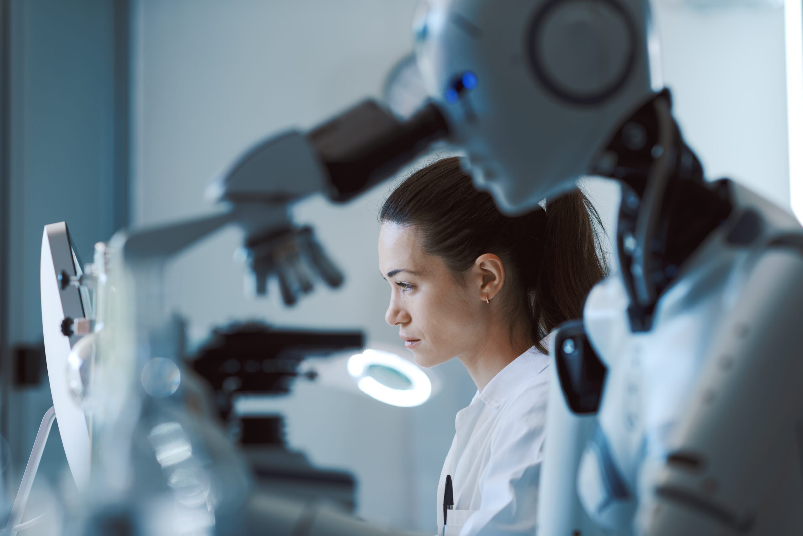 AI robot examining samples under a microscope AI robot examining samples under a microscope